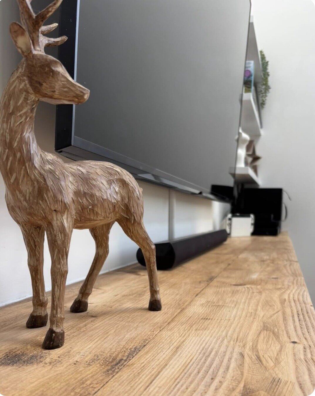 Rustic timber worktop detail on media wall