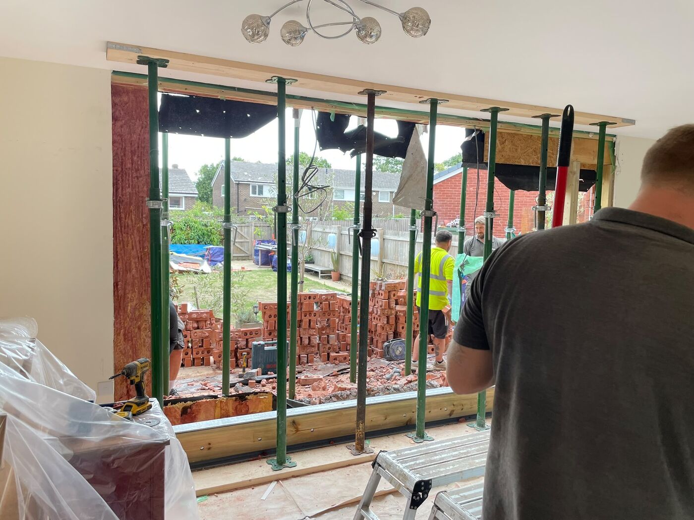 New structural opening formed and temporarily propped, viewed from inside the lounge