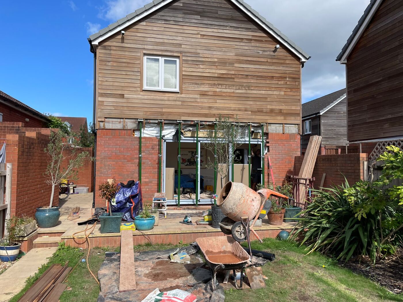 Bi-fold doors installed with propping still in place and brickwork made good