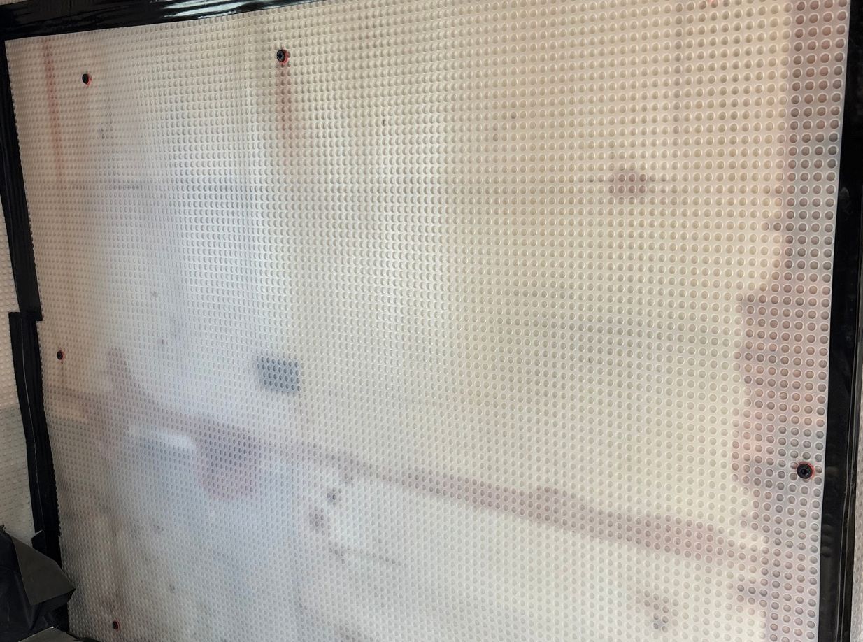 Damp proof membrane with taped joints around the wall edges