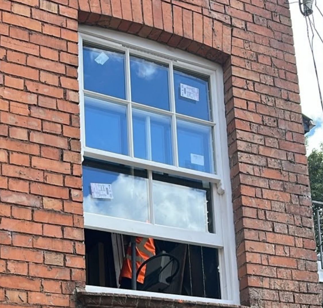 New timber sash window fitted in an arched brick opening